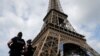 FILE - French police patrol near the Eiffel tower as part of security measures in Paris, France, July 13, 2017. 