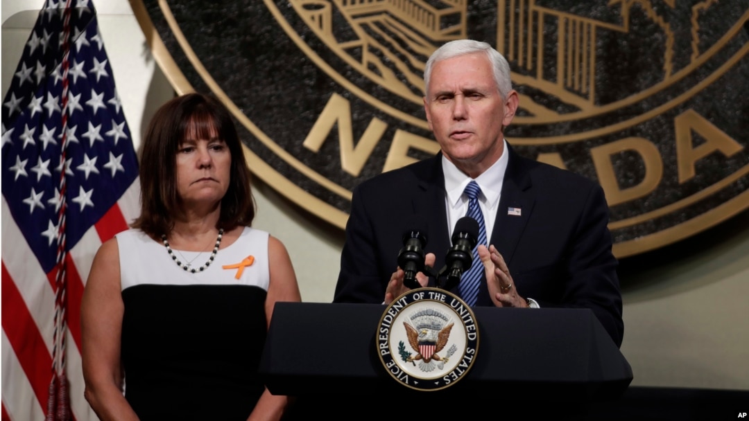 Vice President Mike Pence, accompanied his wife, Karen, speaks in Las Vegas, Oct. 7, 2017, following a unity prayer walk honoring the victims of last weekend's massacre.