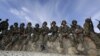 Afghan soldiers wait before the handover ceremony between French army and ANA (Afghan National Army) at the forward operational base of Nijrab as part of the withdrawal of the French troops November 20, 2012. 