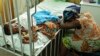 Hassana Ousmane rHassana Ousmane rests her head against the bed where 21-month-old Zeinab, suffering from diarrhea, rests, Princess Marie Louise Children's Hospital, Accra, April 25, 2012.sts her head against the bed where her 21-month-old daughter Zeinab
