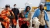 FILE - Migrants disembarks from a coast guard vessel in the Sicilian harbour of Augusta, Italy, Feb. 25, 2017.