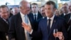 French President Emmanuel Macron, right, samples local produce and wine as he tours the exhibition hall on the opening day of the G7 summit, in Anglet, France, Aug.24, 2019. 