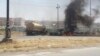 Burning vehicles belonging to Iraqi security forces are seen during clashes between security forces and al Qaida-linked Islamic State in Iraq and the Levant (ISIL) in the northern city of Mosul, June 10, 2014.