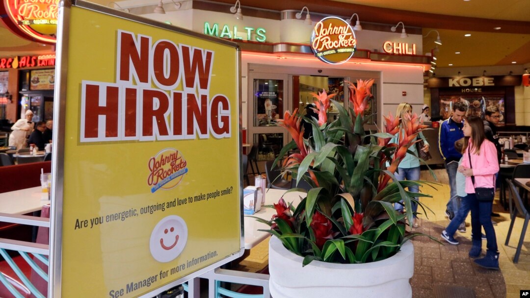 FILE - А restaurant posts a sign indicating it is hiring, in Miami, Feb. 9, 2016.