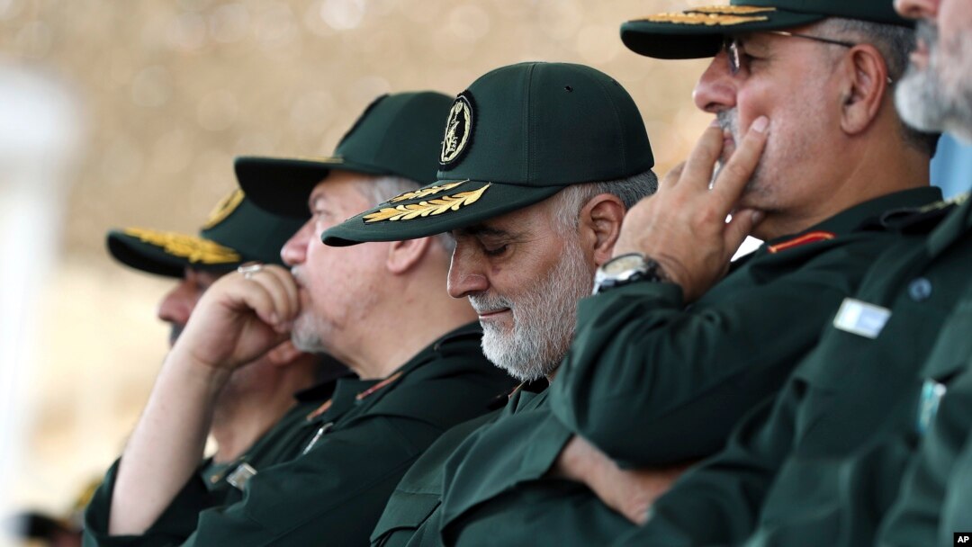Gen. Qassem Soleimani, center, who heads the elite Quds Force of Iran's Revolutionary Guard attends a graduation ceremony of a group of the guard's officers in Tehran, Iran, June 30, 2018.