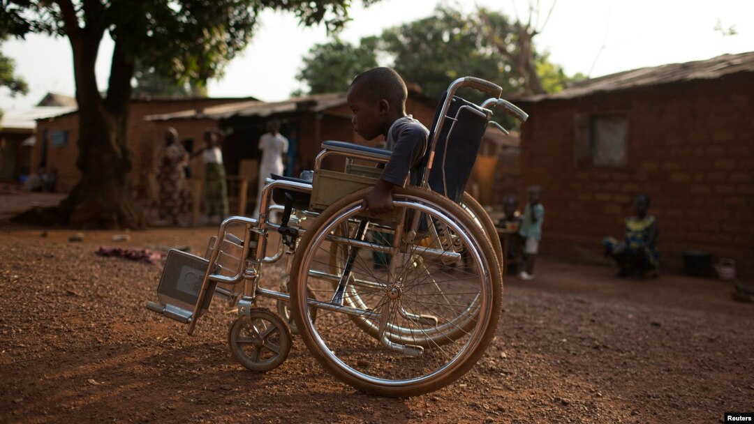 Giovanni Mougounou, 10, who lost both legs in April 2013 to what his family say was a rocket-propelled grenade launched by Seleka fighters on a church, pushes his wheel chair in the Boy Rabe district of Bangui, Central African Republic, February 4, 2014.