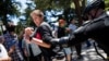 A police officer grabs a man antagonizing "anti-fascist" protestors after multiple people were stabbed during a clash between neo-Nazis holding a permitted rally and counter-protestors on Sunday at the state capitol in Sacramento, California, United State