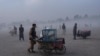 Street vendors push their carts in Chaman-e-Hozori park, Kabul, Afghanistan, Dec. 3 , 2021.