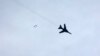 FILE - A Syrian government warplane fires rockets during an airstrike on Eastern Ghouta, near Damascus, Syria, Jan. 25, 2015.