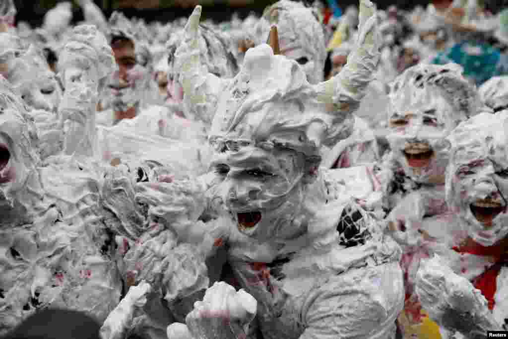 Students from St. Andrews University are covered in foam as they take part in the traditional &#39;Raisin Weekend&#39; in the Lower College Lawn, at St Andrews in Scotland, Britain.