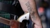 FILE - Scott Smith, a supporter of open carry gun laws, wears a pistol as he prepares for a rally in support of open carry gun laws at the Capitol in Austin, Texas, Jan. 26, 2015. 