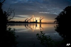 FILE - The coal-fired Scherer Plant, one of the top carbon emitters in the U.S., is seen in Juliette, Georgia, June, 3, 2017.