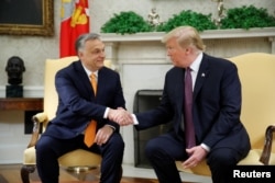 FILE - President Donald Trump greets Hungary's Prime Minister Viktor Orban in the Oval Office at the White House in Washington, May 13, 2019.