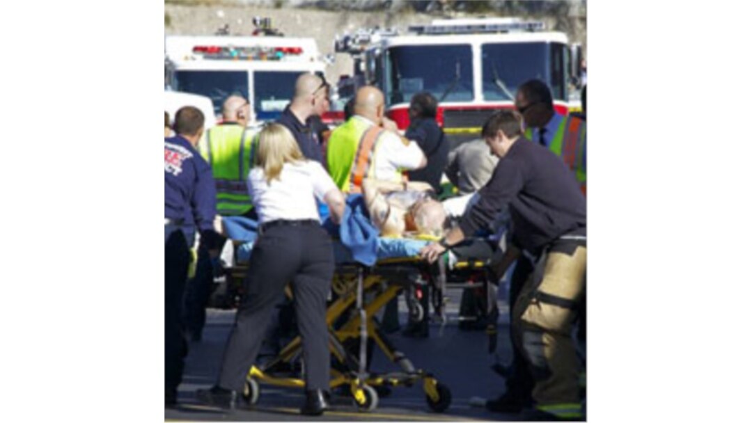 Emergency workers treat a victim of the shooting at a Tucson shopping center