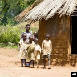 In Uganda, Victoria Ddundu, 46, a widow and mother of 5, walks with her children in a village in Palisa. Her family relies on the food she grows.