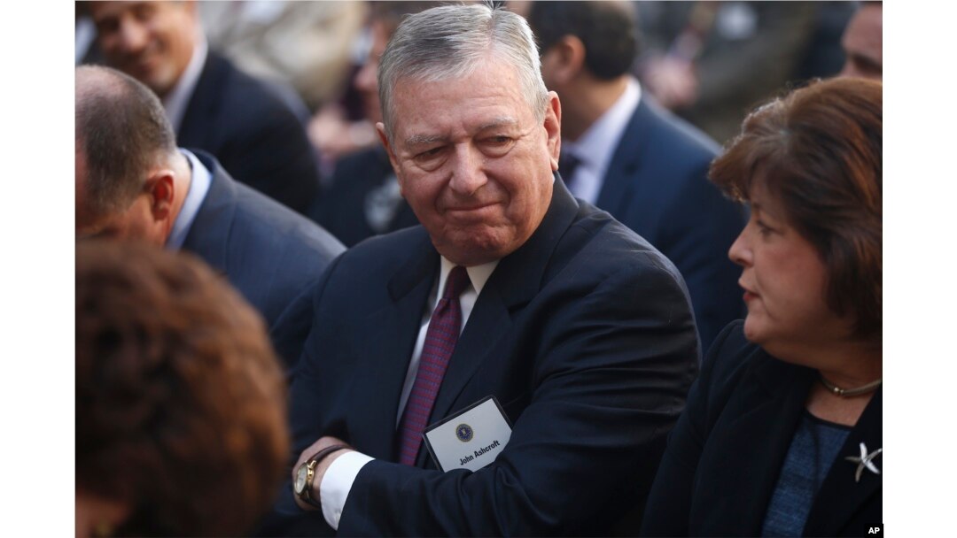 FILE - Former Bush administration Attorney General John Ashcroft is seated before President Barack Obama and FBI Director James Comey arrive at an installation ceremony at FBI Headquarters in Washington, Oct. 28, 2013.