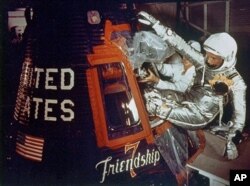 FILE - Astronaut John Glenn climbs into the Friendship 7 space capsule atop an Atlas rocket at Cape Canaveral, Fla., for the flight which made him the first American to orbit the Earth, Feb. 20, 1962.