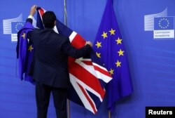 Flags are arranged at the EU Commission headquarters ahead of a first full round of talks on Brexit, Britain's divorce terms from the European Union, in Brussels, Belgium, July 17, 2017.