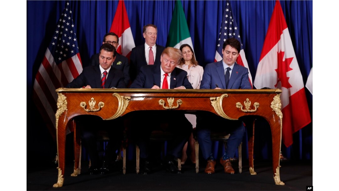 FILE - President Donald Trump, Canada's Prime Minister Justin Trudeau, right, and Mexico's then-President Enrique Pena Nieto, left, participate in the USMCA signing ceremony, Nov. 30, 2018, in Buenos Aires, Argentina.