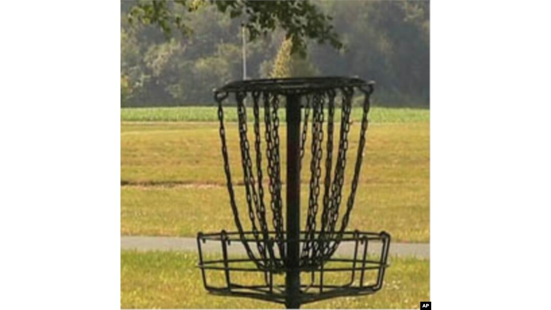 Instead of shooting for a hole on the green, disc golf players aim for a raised metal basket.
