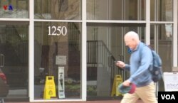 FILE - A man walks past a Washington office building housing Iran's Interests Section at 1250 23rd St. NW, April 25, 2018. (VOA Persian)