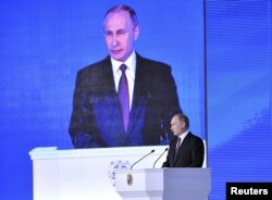 Russian President Vladimir Putin addresses Russian lawmakers, regional governors and other high-ranking officials, in Moscow, Russia, March 1, 2018.