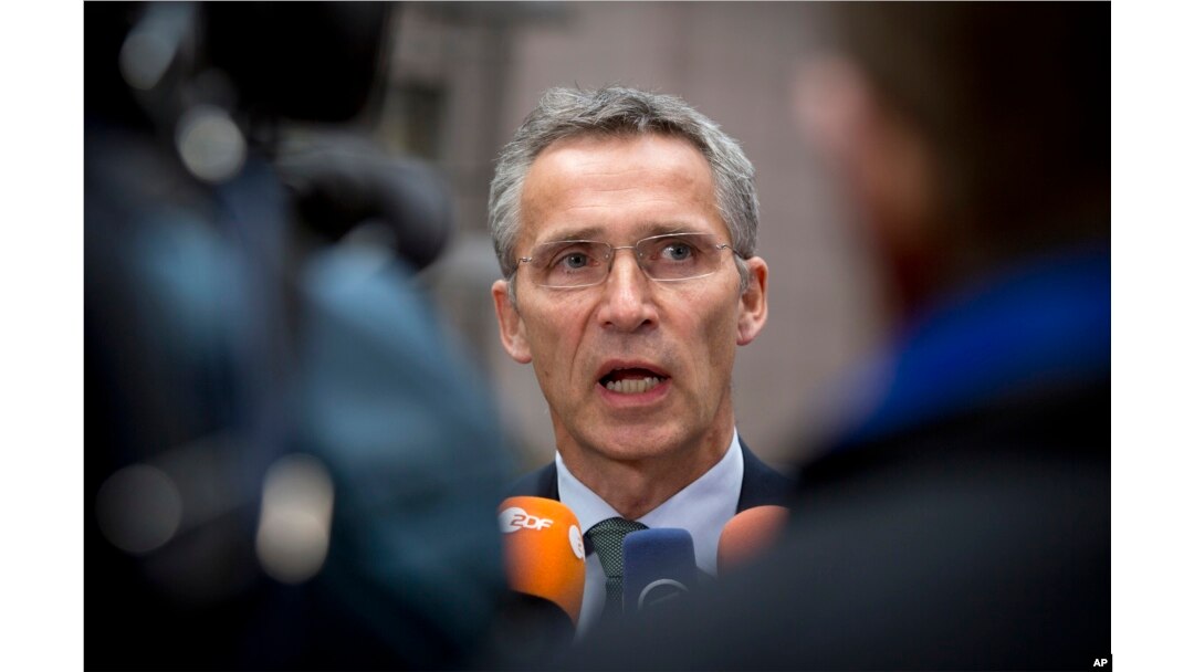 NATO Secretary General Jens Stoltenberg speaks with the media as he arrives for a meeting with European Union defense ministers at the EU Council building in Brussels, Nov. 18, 2014.