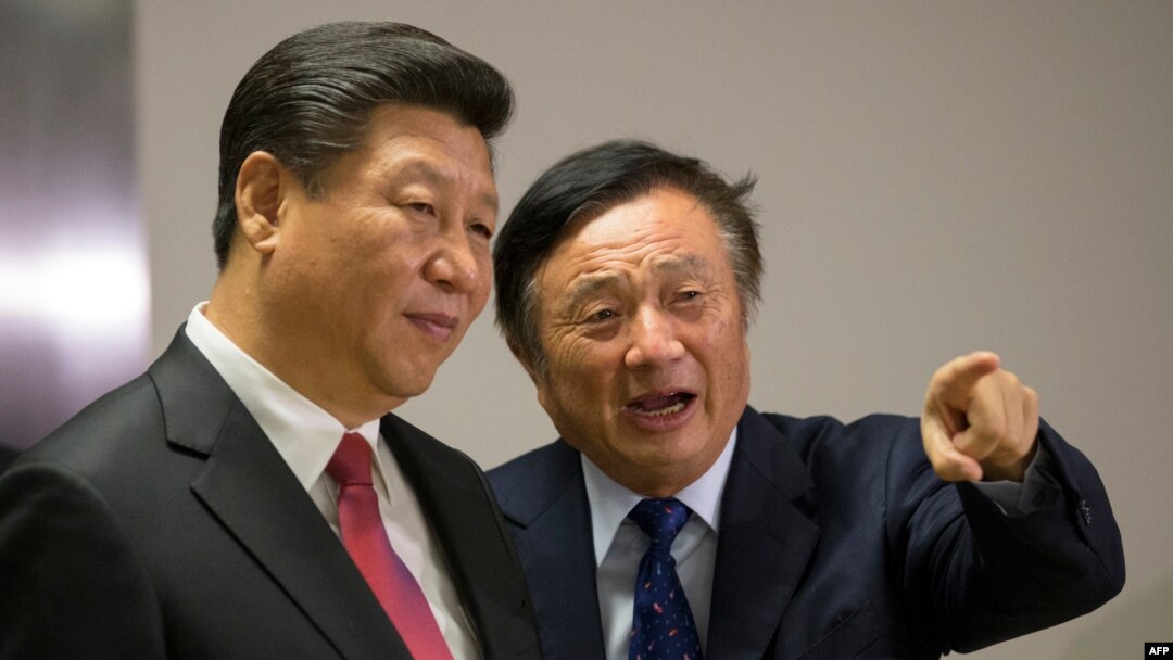 FILE - Chinese President Xi Jinping, left, is shown around the offices of Chinese tech firm Huawei technologies by its President Ren Zhengfei in London during his state visit, Oct. 21, 2015.