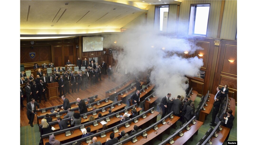 Opposition politicians release tear gas in parliament to obstruct a session in Pristina, Kosovo, Feb. 19, 2016.