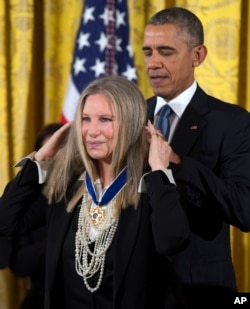 President Barack Obama, right, presents the Presidential Medal of Freedom to Barbra Streisand during a ceremony Nov. 24, 2015, in the East Room of the White House.