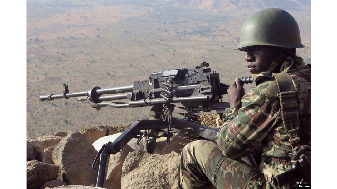 FILE - A Cameroonian soldier guards at an observation post on a hill in the Mandara Mountain chain in Mabass overlooking Nigeria, northern Cameroon, February 16, 2015. Boko Haram militants kidnapped some 80 people from the village a month earlier.