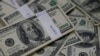 FILE - Bundles of U.S. $100 bills, Aug. 2, 2013. 