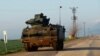 Turkish soldiers ride in an armoured personnel carrier (APC) as they patrol in a village near the Turkish-Syrian border in Hatay province, Turkey, Jan. 28, 2018. 