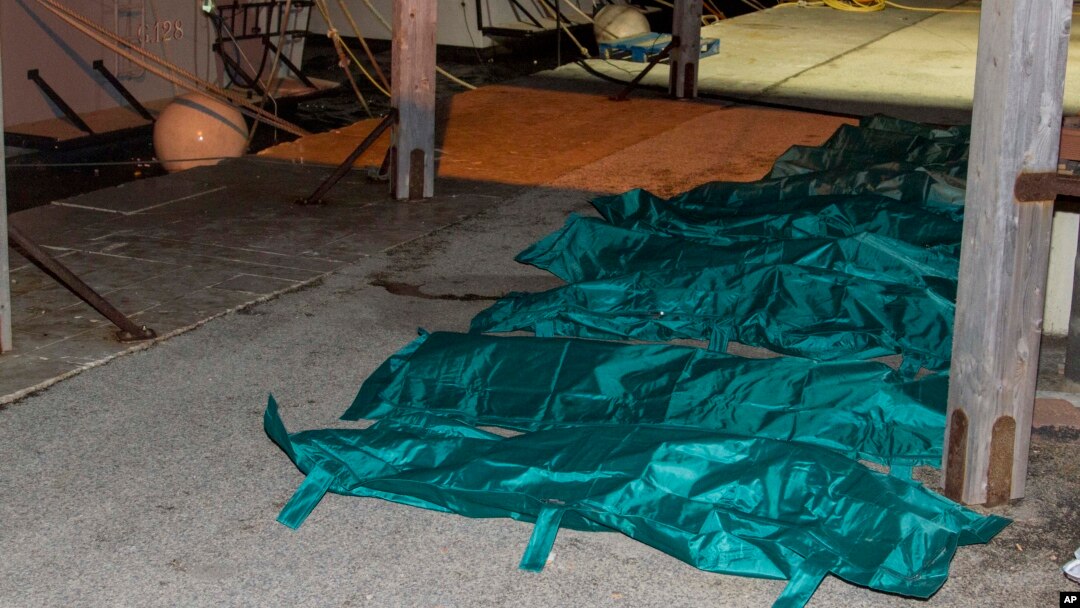 Bodies are lined up in the harbor of Lampedusa, Feb. 9, 2015. 