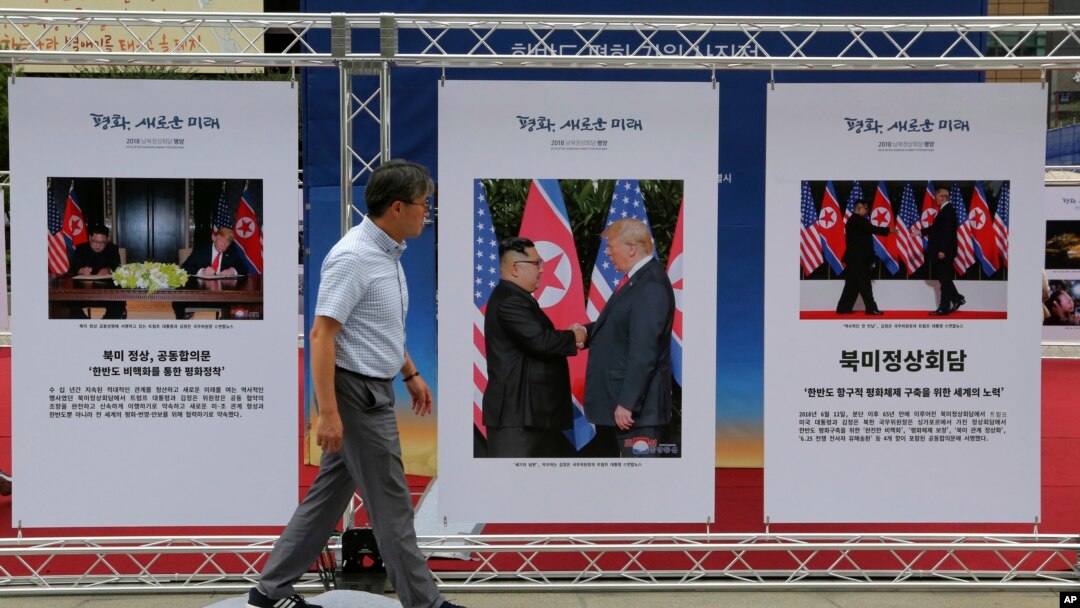 FILE - Photos of the summit between U.S. President Donald Trump and North Korean leader Kim Jong Un are displayed in Seoul, South Korea, Sept. 19, 2018. 