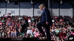 FILE - President Donald Trump arrives at W.K. Kellogg Airport to attend a campaign rally in Battle Creek, Mich., , Dec. 18, 2019.
