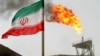 FILE - A gas flare on an oil production platform is seen alongside an Iranian flag in the Gulf, July 25, 2005. On Dec. 19, 2024, the U.S. sanctioned three vessels involved in the trade of Iranian petroleum and petrochemicals.