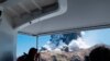 FILE - In this Dec. 9, 2019, file photo provided by Michael Schade, tourists on a boat look at the eruption of the volcano on White Island, New Zealand.