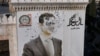 This aerial picture shows a bullet-riddled portrait of Syrian President Bashar al-Assad adorning Hama's municipality building after it was defaced following the capture of the city by anti government fighters, Dec. 6, 2024. 