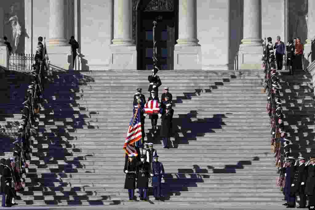 The flag-draped casket of former President Jimmy Carter is carried from the U.S. Capitol on the way to a state funeral at the National Cathedral, in Washington, Jan. 9, 2025. 