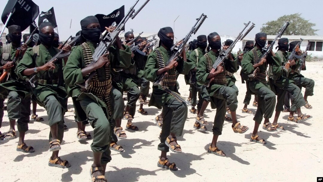 FILE - Hundreds of newly trained al-Shabab fighters perform military exercises in the Lafofe area, south of Mogadishu, Somalia.