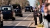 A young boy salutes as the hearse carrying the flag-draped casket of former President Jimmy Carter moves through downtown Plains, Georgia, Jan. 4, 2025. 