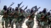 FILE - Al-Shabab fighters are seen marching with their weapons during exercises on the outskirts of Mogadishu, Somalia, Feb. 17, 2011. The Pentagon says a U.S. airstrike against al-Shabab in Somalia last Saturday killed more than 150 militants.