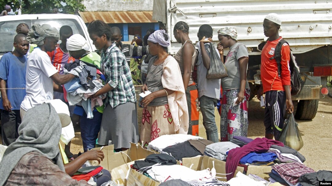 FILE - Families queue at a United Nations Human Rights Council (UNHRC) centre for Burundi refugees in Uvira to receive food ration and clothing in South Kivu in the Democratic Republic of Congo (DRC) May 20, 2015.