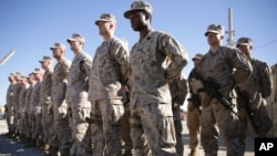 FILE - US Marines watch during a change of command ceremony at Task Force Southwest military field, Helmand province, Afghanistan, Jan. 15, 2018.