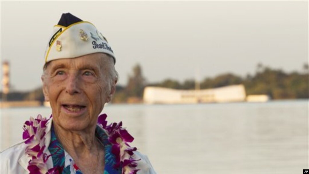 With the USS Arizona memorial in the background, Pearl Harbor survivor Richard Laubert, of Phoenix, Oregon, attends the 69th anniversary ceremony marking the attack on Pearl Harbor, 7 Dec 2010, in Pearl Harbor, Hawaii