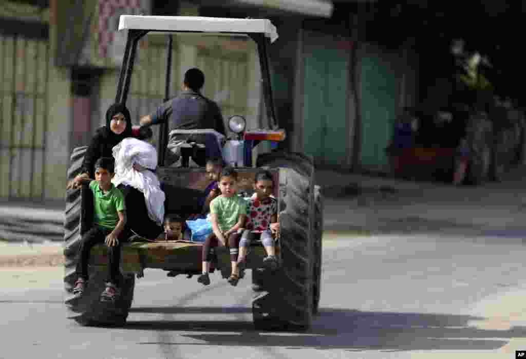 Palestinians flee their homes to take shelter at the United Nations school in Gaza City, Sunday, July 13, 2014.