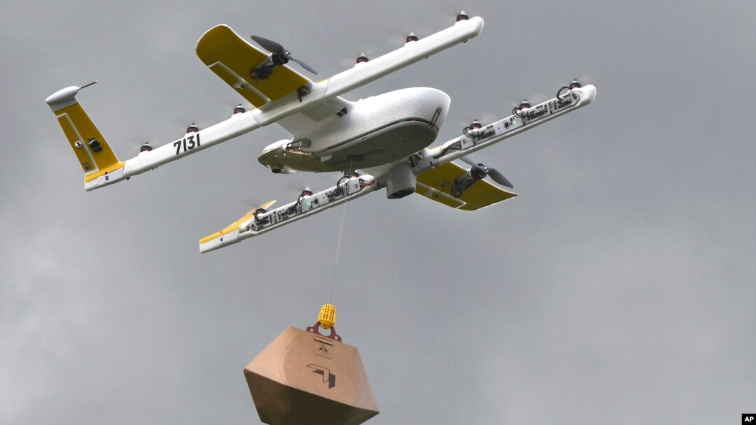In this Tuesday, Aug, 7, 2018, photo a Wing Hummingbird drone carries a package of ice cream and popsicles as it leaves its launch site during a delivery flight demonstration in Blacksburg, Va. (Michael Shroyer via AP)