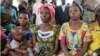FILE - Women from a camp for displaced people in Kitchanga, in eastern Democratic Republic of Congo, listen to Margot Wallstrom, the UN's special representative on sexual violence.