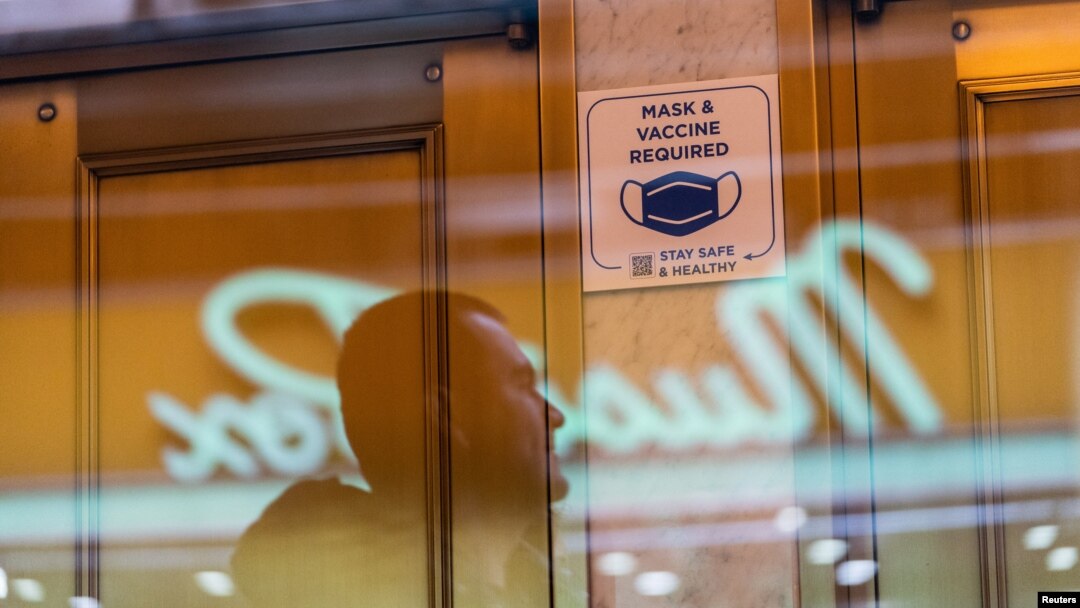 FILE - A sign posted on the door of a theater requiring patrons to be vaccinated against COVID-19, is seen in Times Square, in New York City, Dec. 16, 2021.